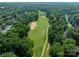 Aerial view of the golf course in a community lined with green trees and foliage at 4201 Beauvista Dr, Charlotte, NC 28269