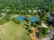 Aerial view of community amenities including tennis courts, a playground, and a sand volleyball court at 4201 Beauvista Dr, Charlotte, NC 28269
