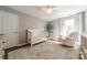Peaceful Bedroom with hardwood floors, neutral colors, and a comfortable rocking chair at 4201 Beauvista Dr, Charlotte, NC 28269