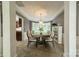 Open dining room with a chandelier and seating for eight, next to the open kitchen at 4201 Beauvista Dr, Charlotte, NC 28269