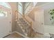 Welcoming two-story foyer with a carpeted staircase, decorative railing, and ample natural light from the arched window at 4201 Beauvista Dr, Charlotte, NC 28269