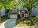 Beautiful two-story home features a well-manicured lawn, two car garage, and a vibrant red front door at 4201 Beauvista Dr, Charlotte, NC 28269