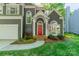 Charming two-story home with a red front door, arched windows, and a well-manicured lawn at 4201 Beauvista Dr, Charlotte, NC 28269