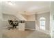 Bright hallway features a neutral color scheme, carpeted floor, and natural light from arched window at 4201 Beauvista Dr, Charlotte, NC 28269