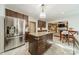 Kitchen featuring an island, stainless steel fridge, and view into the living room at 4201 Beauvista Dr, Charlotte, NC 28269