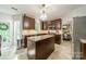 Kitchen with island, stainless steel appliances, dark cabinets, and dining area access at 4201 Beauvista Dr, Charlotte, NC 28269