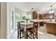 Bright kitchen and breakfast nook featuring a table with seating and views of the backyard at 4201 Beauvista Dr, Charlotte, NC 28269