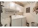 Functional laundry room featuring white front load machines, upper cabinets, and laundry-themed decor at 4201 Beauvista Dr, Charlotte, NC 28269