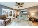 Cozy living room with a neutral sofa, a ceiling fan, and an open view to the kitchen at 4201 Beauvista Dr, Charlotte, NC 28269