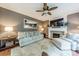 Inviting living room featuring a fireplace, comfortable seating, and a ceiling fan at 4201 Beauvista Dr, Charlotte, NC 28269