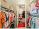 Organized walk-in closet with shelves and clothing racks for ample storage, featuring a doorway to an additional space at 4201 Beauvista Dr, Charlotte, NC 28269