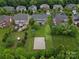 Aerial view of fenced backyard with basketball court, mature landscaping, and large trees at 422 Deer Brush Ln, Waxhaw, NC 28173