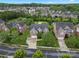 Expansive aerial view of brick home showcasing manicured lawns, mature trees, and a peaceful neighborhood setting at 422 Deer Brush Ln, Waxhaw, NC 28173