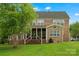 Expansive brick home featuring a spacious deck and lush green lawn, perfect for outdoor living and entertaining at 422 Deer Brush Ln, Waxhaw, NC 28173