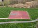 Aerial view of a community basketball court surrounded by lush green grass and a walking path at 422 Deer Brush Ln, Waxhaw, NC 28173