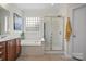 Elegant bathroom featuring a soaking tub, separate shower, and tiled flooring at 422 Deer Brush Ln, Waxhaw, NC 28173