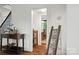 The entryway features wood flooring, a staircase, decorative furnishings, and arched doorway to dining room at 422 Deer Brush Ln, Waxhaw, NC 28173