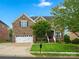 Beautiful brick two-story home with well-manicured lawn, two-car garage, and lovely curb appeal at 422 Deer Brush Ln, Waxhaw, NC 28173
