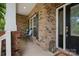 Charming front porch with seating area, brick columns, and elegant front door at 422 Deer Brush Ln, Waxhaw, NC 28173