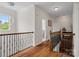 Upstairs hallway features hardwood floors and a decorative chandelier, leading to the bedrooms at 422 Deer Brush Ln, Waxhaw, NC 28173