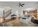Spacious living room featuring hardwood floors, a staircase, and views into the kitchen at 422 Deer Brush Ln, Waxhaw, NC 28173