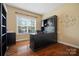 Home office featuring hardwood floors and a large built-in desk at 422 Deer Brush Ln, Waxhaw, NC 28173