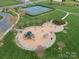 Aerial view of a playground with slides, swings, and climbing structures on a manicured lawn at 422 Deer Brush Ln, Waxhaw, NC 28173
