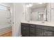 Bright bathroom featuring double sinks, a large mirror, modern fixtures, and a shower-tub combo at 423 Shallowford Dr, Rock Hill, SC 29732