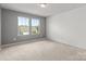 Bedroom with neutral carpet and gray accent wall with windows at 423 Shallowford Dr, Rock Hill, SC 29732