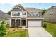 Charming two-story home featuring a brick and siding exterior, attached two car garage, and landscaped front yard at 423 Shallowford Dr, Rock Hill, SC 29732