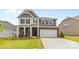 Classic two-story home with brick and siding, attached two car garage, and inviting curb appeal at 423 Shallowford Dr, Rock Hill, SC 29732