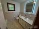 Tiled bathroom featuring a vanity and combination shower and tub at 5068 King Wilkinson Rd, Denver, NC 28037
