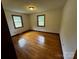 Bright bedroom with hardwood floors and natural light from two windows at 5068 King Wilkinson Rd, Denver, NC 28037