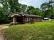 Quaint brick home with a covered front porch, small brick steps and landscaped yard at 5068 King Wilkinson Rd, Denver, NC 28037