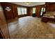 Spacious living room featuring a brick fireplace and laminate flooring at 5068 King Wilkinson Rd, Denver, NC 28037