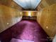 Interior view of carpeted outbuilding with paneling and small window at 5068 King Wilkinson Rd, Denver, NC 28037