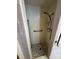 Shower stall with tiled walls, grab bar, and patterned floor, designed for accessibility at 5068 King Wilkinson Rd, Denver, NC 28037