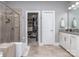 Bright bathroom featuring tiled shower, granite vanity, and an open closet for ample storage space at 5130 Mount Clare Ln, Charlotte, NC 28210