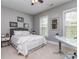 Bright bedroom with comfortable bed, desk, and multiple windows offering natural light at 5130 Mount Clare Ln, Charlotte, NC 28210