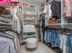 Organized walk-in closet featuring shelves, hanging racks, and a cozy ottoman at 5130 Mount Clare Ln, Charlotte, NC 28210