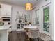 Bright dining area with designer light fixture and bar area, and access to outdoor patio at 5130 Mount Clare Ln, Charlotte, NC 28210