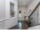 Elegant entryway featuring dark wood floors, decorative wall trim, staircase, and stylish accents at 5130 Mount Clare Ln, Charlotte, NC 28210
