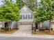 Charming two-story home with a well-maintained lawn, attached garage, and traditional architectural details at 5130 Mount Clare Ln, Charlotte, NC 28210