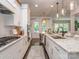 Bright kitchen features white cabinets, stainless appliances, granite countertops, and dark hardwood floors at 5130 Mount Clare Ln, Charlotte, NC 28210
