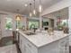 Spacious kitchen island boasts granite countertops, stainless steel sink, and pendant lighting at 5130 Mount Clare Ln, Charlotte, NC 28210