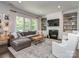 Spacious living room featuring a comfortable sectional sofa, fireplace, and built-in shelving at 5130 Mount Clare Ln, Charlotte, NC 28210