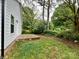 The backyard has a small concrete patio, grass, and surrounding trees at 514 Rich St, Rock Hill, SC 29730