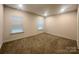 Spacious carpeted bedroom illuminated by natural light from two windows at 514 Rich St, Rock Hill, SC 29730