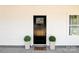 Inviting front entrance features black door, potted plants, and a 'Welcome' doormat at 514 Rich St, Rock Hill, SC 29730