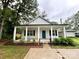 Charming home featuring a welcoming porch with white columns and a vibrant blue front door at 514 Rich St, Rock Hill, SC 29730